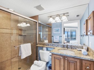 Sparkling clean bathroom with hair dryers provided in the cabinets.