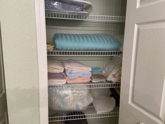 Fully stocked linen closets with extra sheets, blankets, pillows