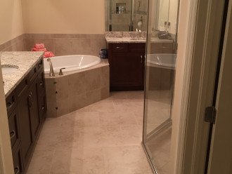 Master bathroom with dual vanities, soaking tub and glass shower