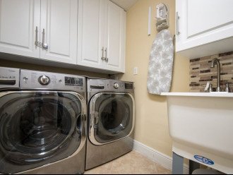 Laundry Room inside condo. New LG washer/dryer, sink, iron board, & dry rack