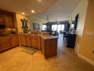 Large Chef's Kitchen leads into dining room, living areas, and bar room.