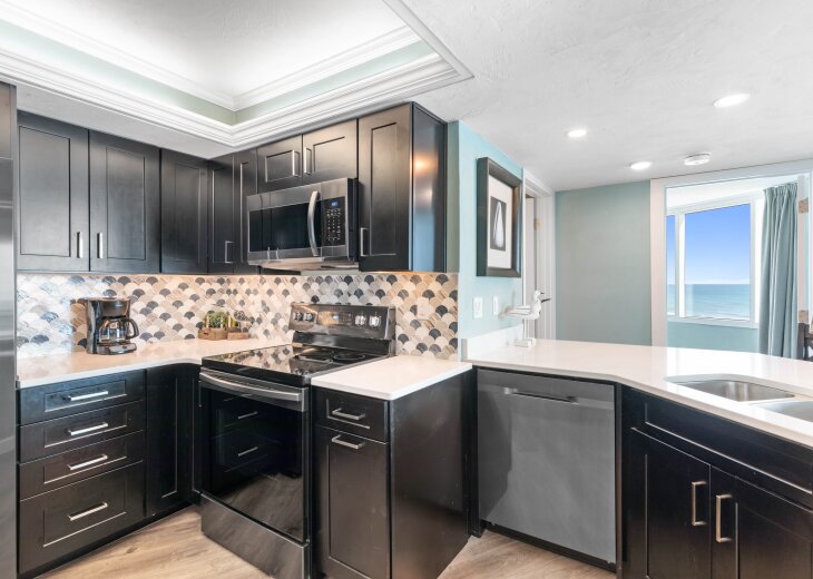 Kitchen opens into living area with large bar.