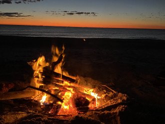 bonfire on the beach by the boardwalk
