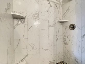 Master bathroom shower with luxury spa stone floor