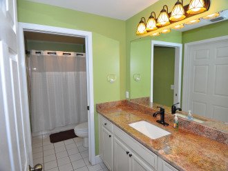 Guest bath with updated granite countertops & cabinets. Separate shower/tub area