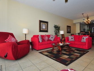 Living room with sofa, love seat, recliner, 2 chairs in warm vibrant colors