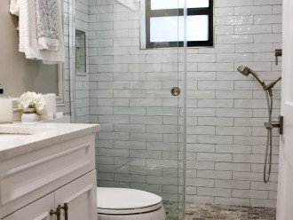 Guest bathroom with fixed and handheld showers.
