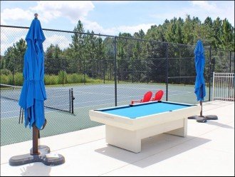 Pool table and table tennis table on the pool deck of Club House