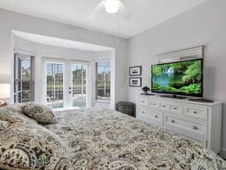 Master bedroom with king size bed and access to pool area