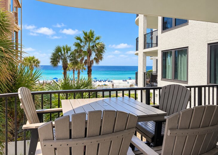 Private balcony with outdoor seating and beautiful Gulf and beach views.