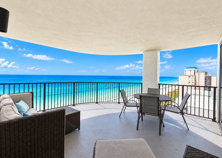 Private balcony with comfortable seating and stunning panoramic Gulf views.