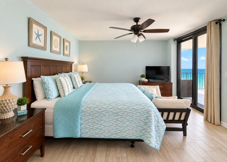 Coastal king bedroom with direct balcony access and beautiful Gulf views.