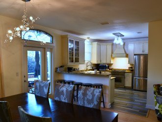 Dining table with seating for 8 & additional bar seating overlooking the kitchen