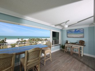 Right side of balcony with large dining table and 56 inch smart HD TV