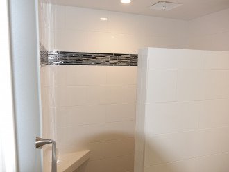 Walk-in to tiled shower with optional overhead rain shower in ceiling