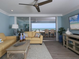 Well furnished living area with floor to ceiling beachfront views