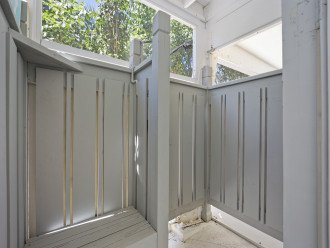 Outdoor shower located near the pool.