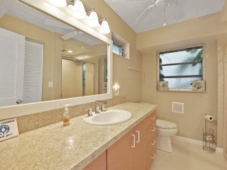 Bathroom located across from pool kitchen on the lower level of the main house.
