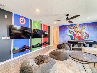 Upstairs game room with video game consoles and air hockey.