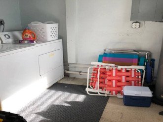 Laundry room with full size washer & dryer. Beach chairs, umbrella and cooler are for your use. Beach towels are stored in the bathroom closet.