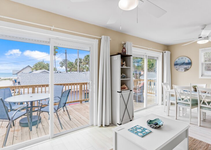 Relax in your bright coastal living space with ocean views through sliding glass doors leading to your private deck.