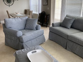 Living room with sofa bed and oversized chair with ottoman
