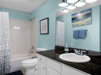 Guest bathroom with granite counter tops, lots of storage, tub/shower combo