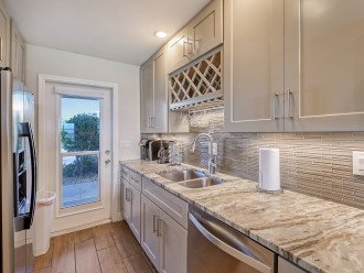 Gorgeous kitchen with door view of boat docks and parking