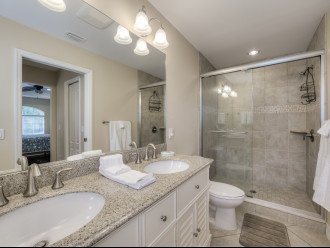 Bathroom with marble countertops and walk-in shower