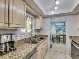 Kitchen with sink, modern appliances, and grantie countertops.