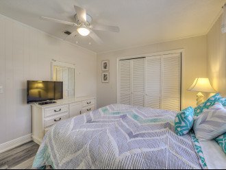White Bedroom with TV at Pelican Beach House