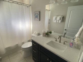 Guest bathroom with quartz vanity top, shower/tub combo is between bedrooms 2&3