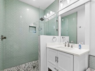 Master shower with great lighting double vanity and storage space.