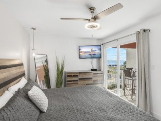 Master bedroom with stunning Gulf views and outdoor access. You'll love waking up to this view!