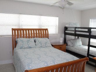 Downstairs queen bed with bunks.