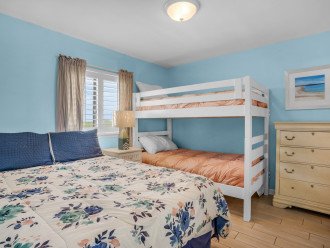 Guest room with queen bed and twin bunks with new bedding