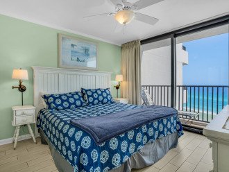 Comfortable king bed in master suite with beach view.