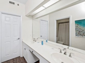 Master bathroom features his and hers sinks and large walk in closet.