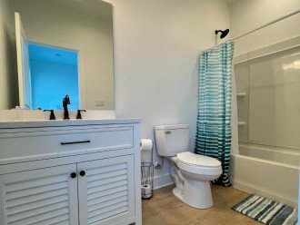 Private bathroom for bedroom 4 with shower tub combo