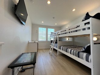 Bunk room with electronic board game system, smart tv, and beverage center