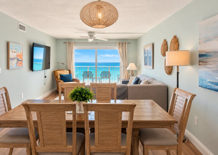 Spacious dining and living area with comfortable seating and beautiful Gulf views from the balcony.