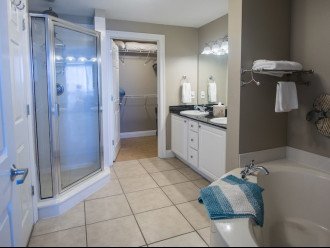 A large soaking tubacross form the potty room, sinks, shower & walk in closet