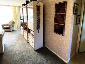 LR display cabinet, faux painted walls, plush nylon carpet, hall to MB on right