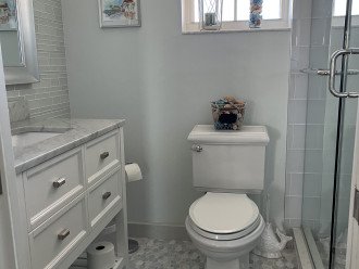 Second bath/guest bath--marble and glass tile throughout with custom artwork