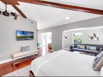 The master bedroom boasts a king size bed, access to the balcony, extra seating and a Smart T.V.