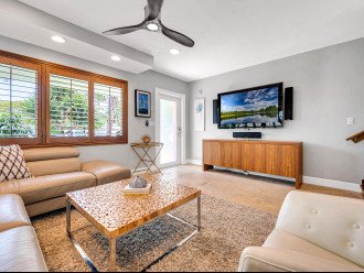 The living area has plenty of comfortable seating, giving everyone room to gather around the wall mounted Smart T.V.