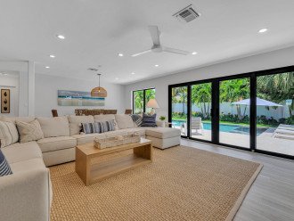 The ample living area overlooking the tropical garden which features a heated pool.