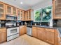 After the dining room you will find the full kitchen, with beautiful black granite tops.