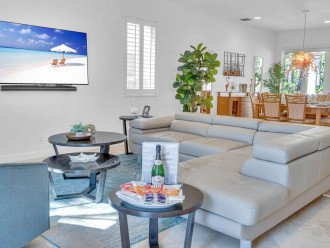 Designed with entertainment in mind, the living area features plenty of comfortable seating surrounding a wall- mounted 65" Smart T.V .