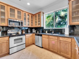 After the dining room you will find the full kitchen, with beautiful black granite tops.